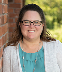 Professional woman with glasses and smiling