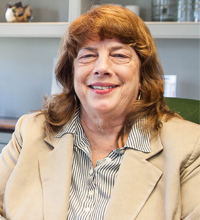 Professional woman smiling sitting in an office