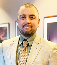 Professional gentleman in a suit standing in the bank's boardroom